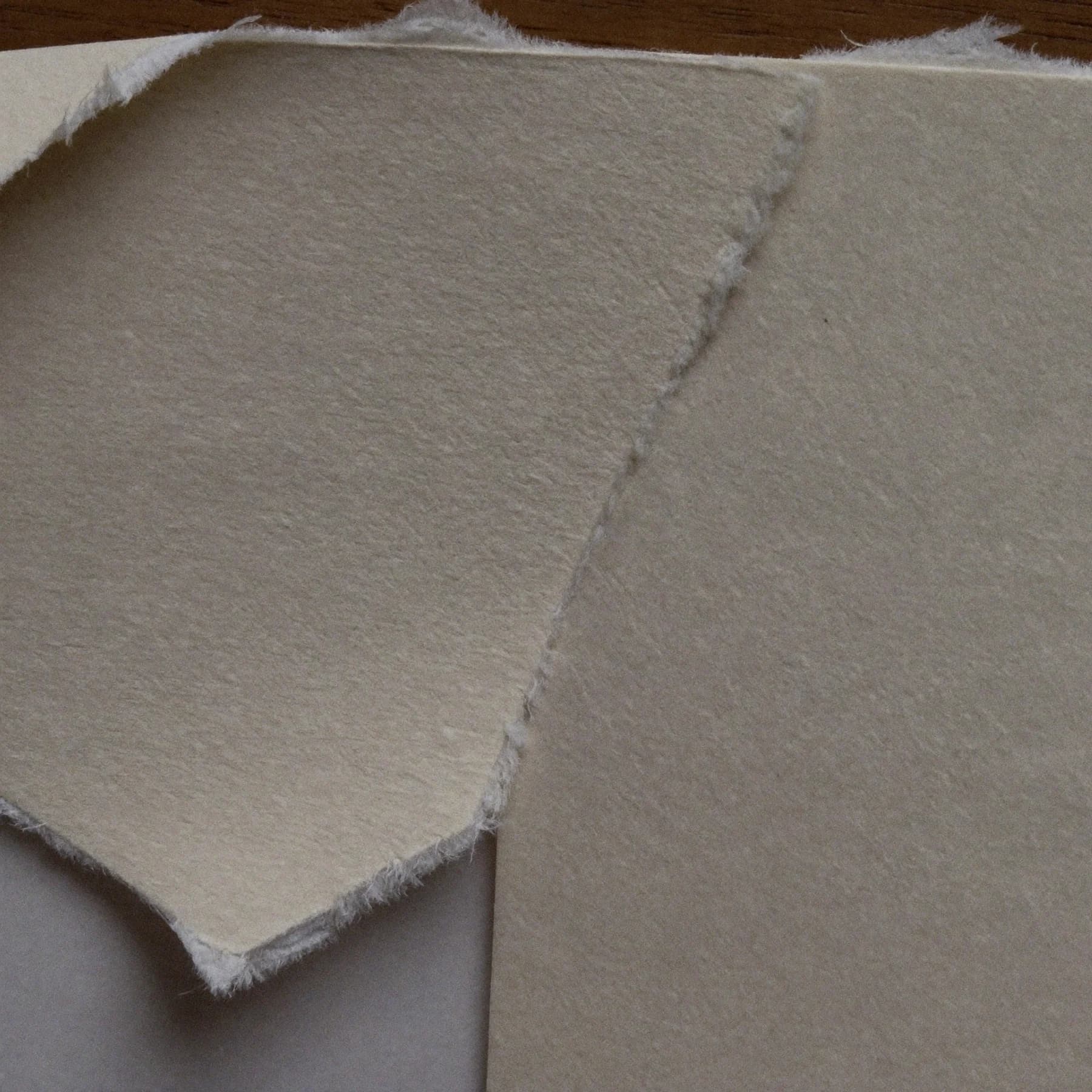 Close-up of the torn deckle edge of cotton rag paper